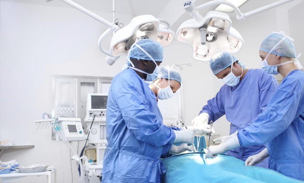 Surgeons performing surgery in an operating theatre together