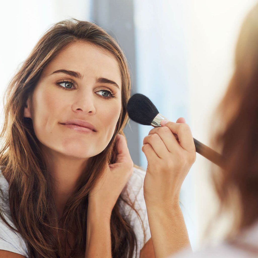 woman applying makeup blend for a natural look