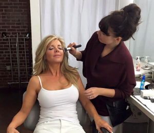 Rachel applying makeup to our real patient model