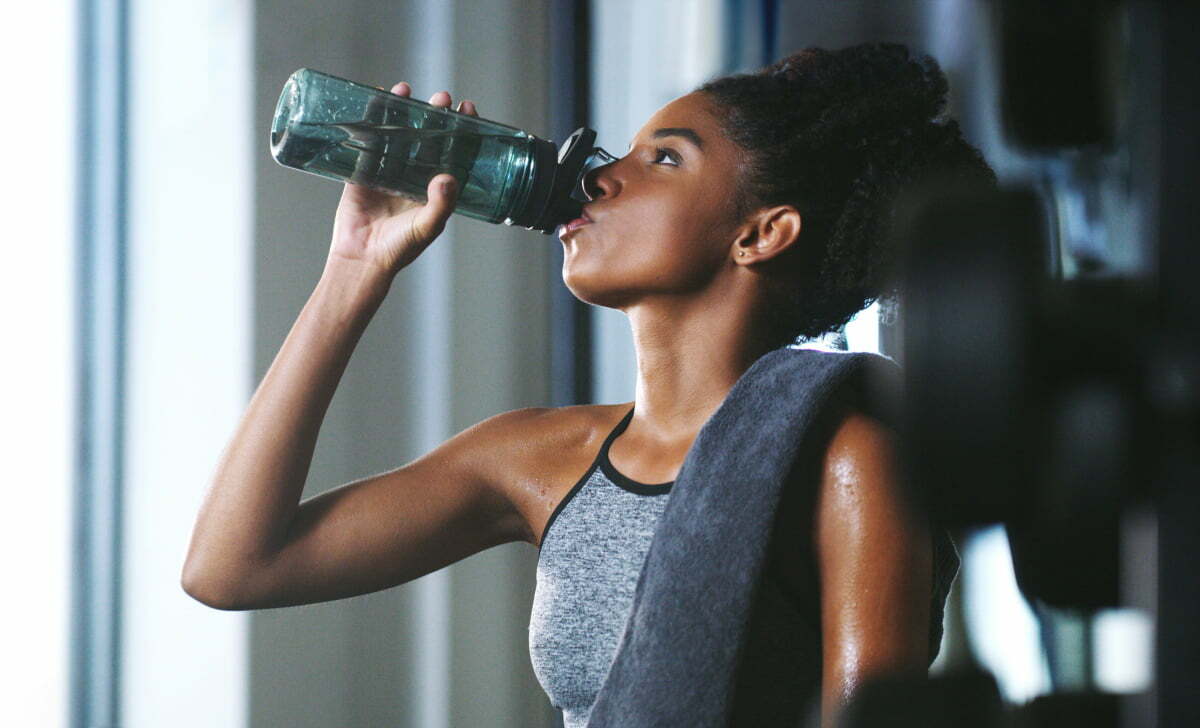 Young Woman Drinking Water During Morning Fat-Burning Fasted Cardio Workout