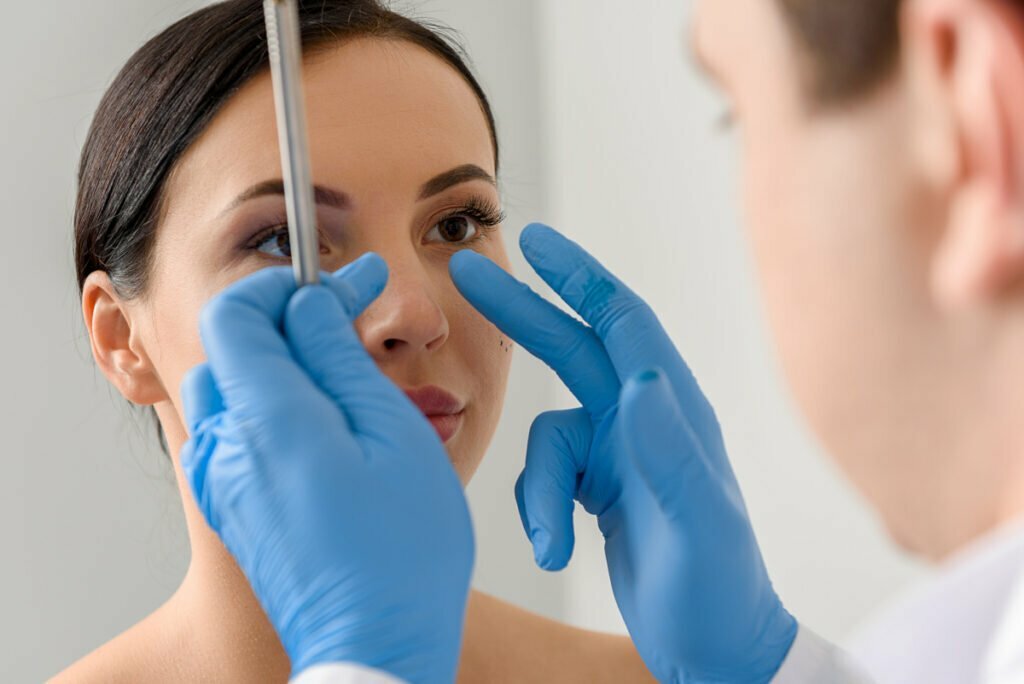 Woman Meets With Plastic Surgeon to Discuss Open vs Closed Rhinoplasties at Consultation