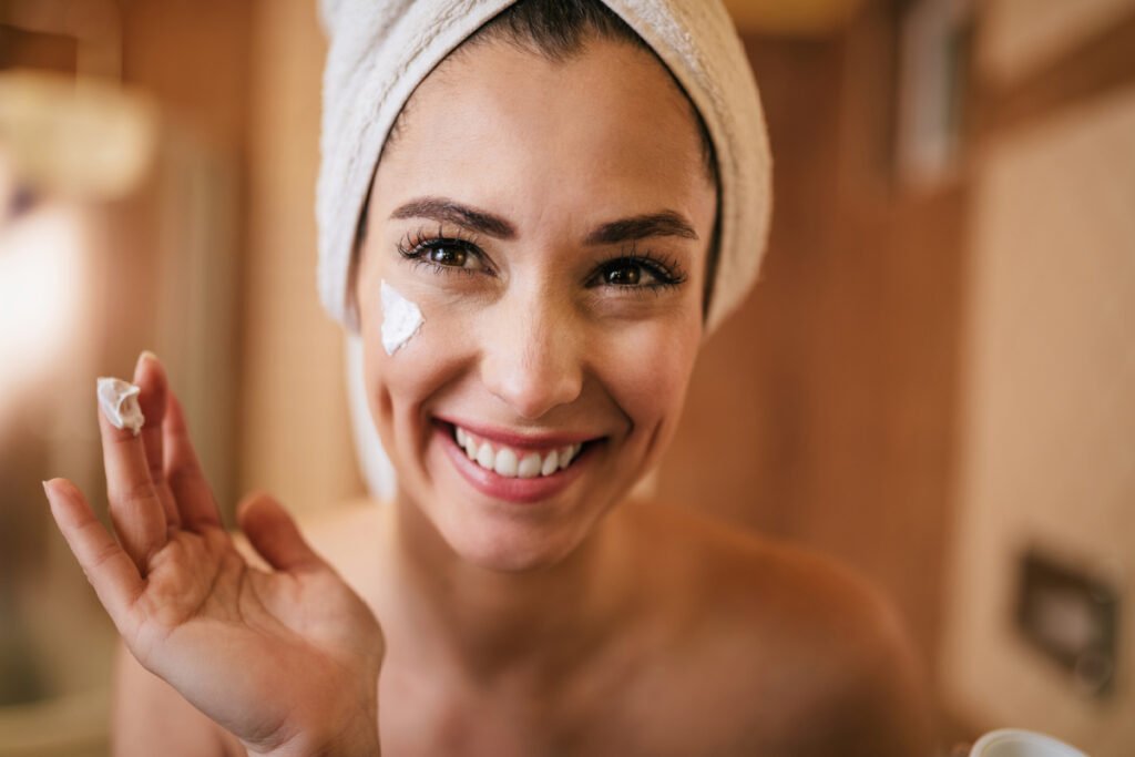 Happy Radiant Woman Applying Skincare After a Laser Skin Treatment