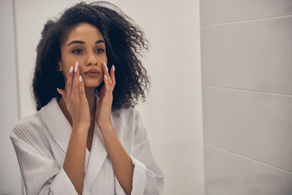 Women Looking at Skin in Mirror Showing signs from Stress