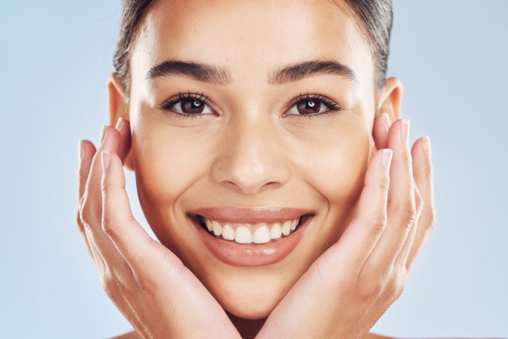 Young woman smiling with smooth skin after wrinkle treatments 