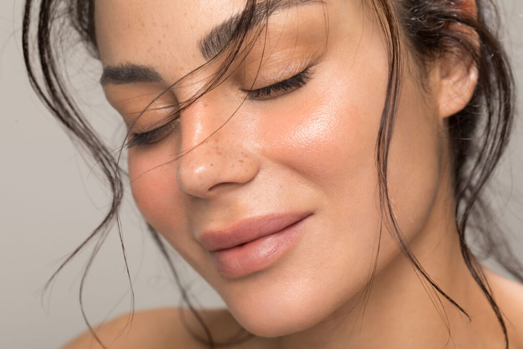 Woman smiling with her eyes closed.